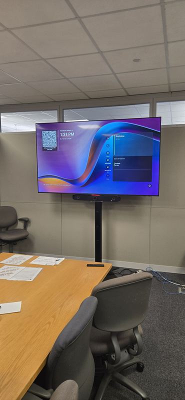 Cart-based room — Rolling display serving a conference table without permanent wall penetrations.