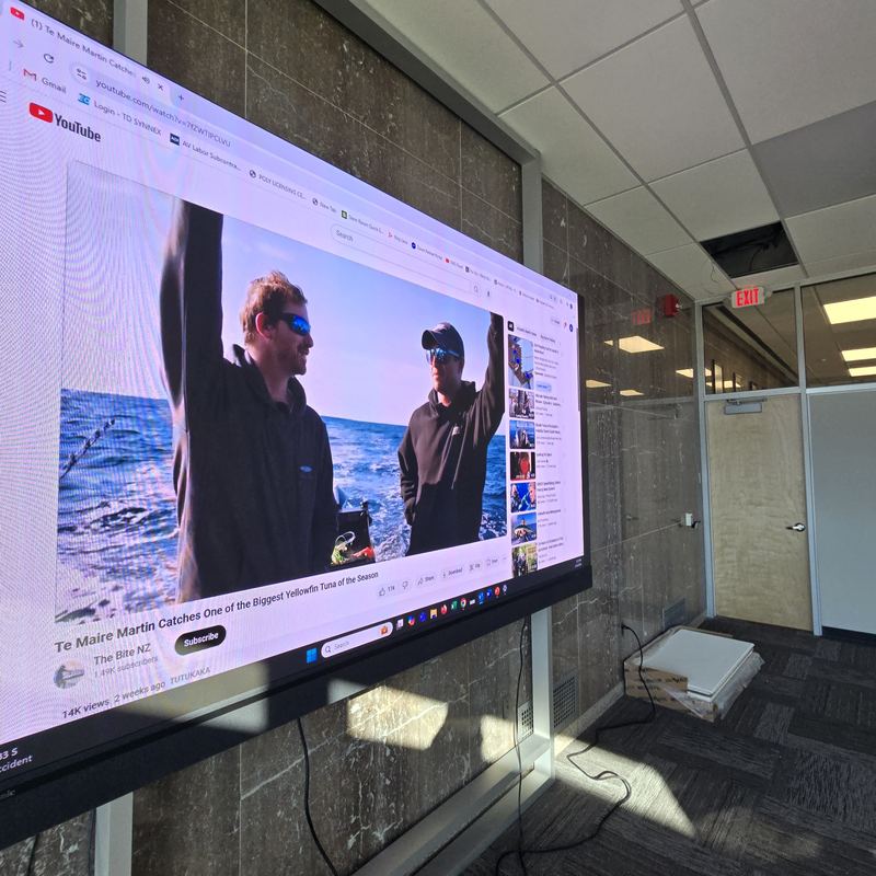 Interactive display, stone wall — Interactive panel mounted to a finished stone feature wall with concealed cabling.