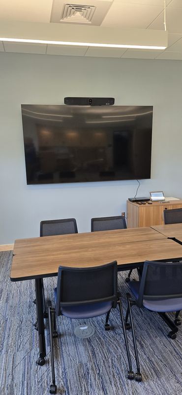 Meeting room — Display and video bar sized to a six-person table.