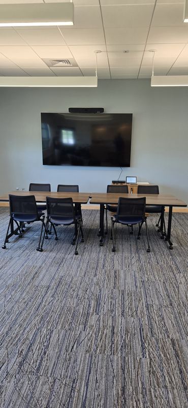 Board room — Longer table, same standards-based layout — one design scaled to a bigger room.